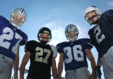 Woodason brothers where their football jerseys and helmets.