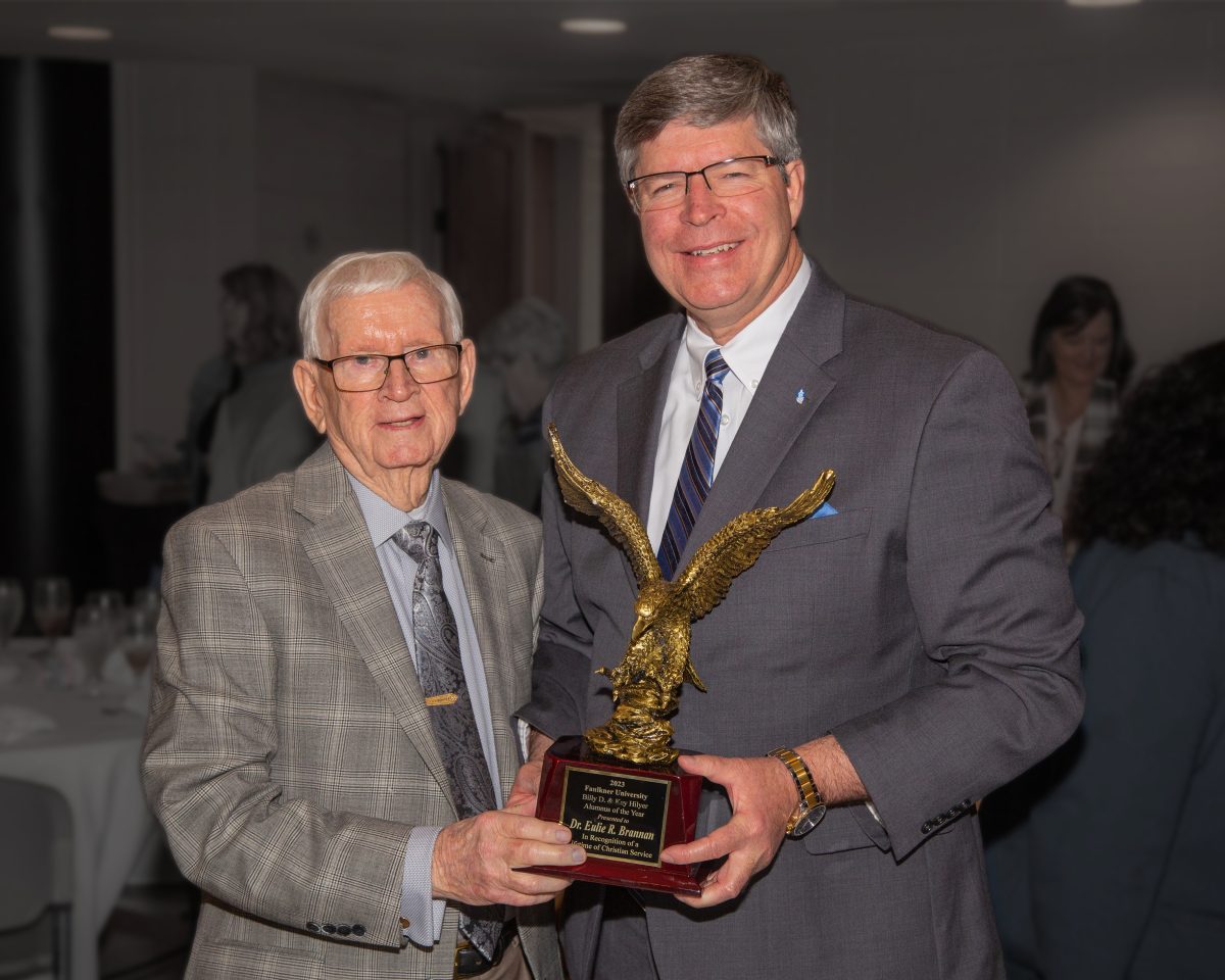 E.R. Brannan receives the Alumnus of the Year Award from President Mitch Henry. 