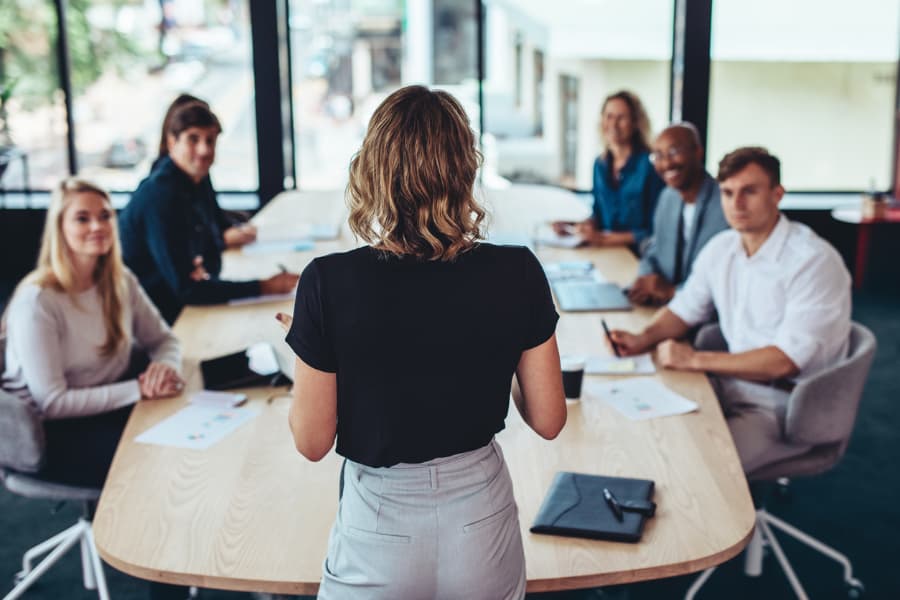 Business administration graduate conducting an employee orientation
