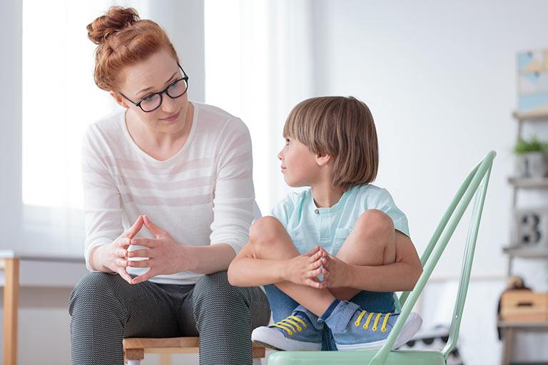 school-counselor-listening-to-young-boy