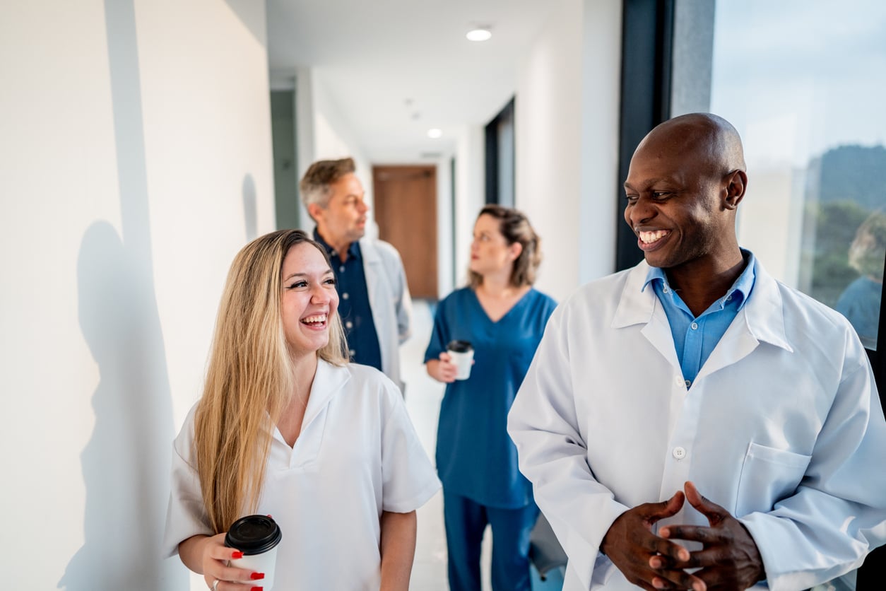 Doctor and nurse talking while walking in the hospital