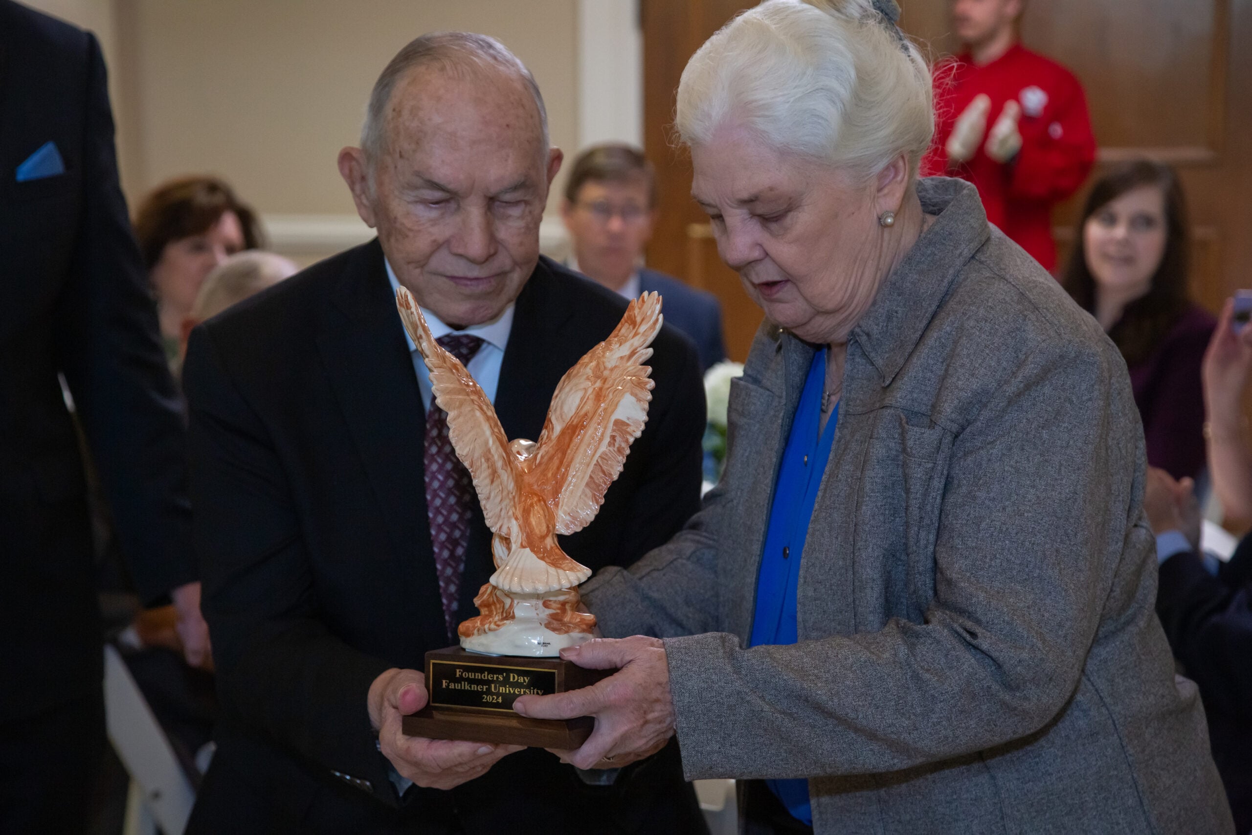 Beau Greer and Joy Greer accept a special Alabama Clay Eagle in honor of their family on Founders Day. 