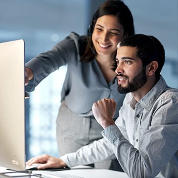Teacher and student looking at computer