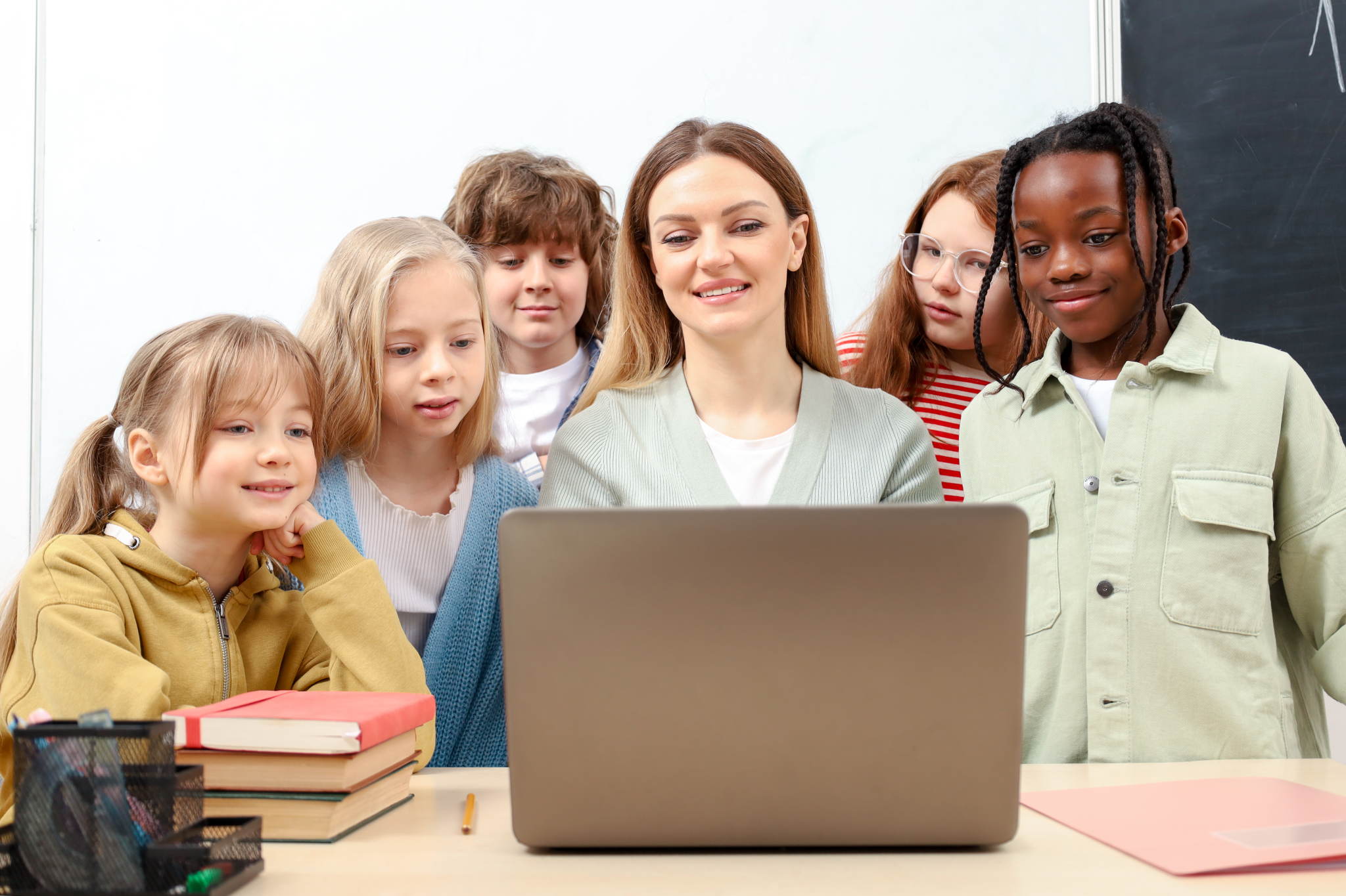 Group of school kids with teacher in classroom