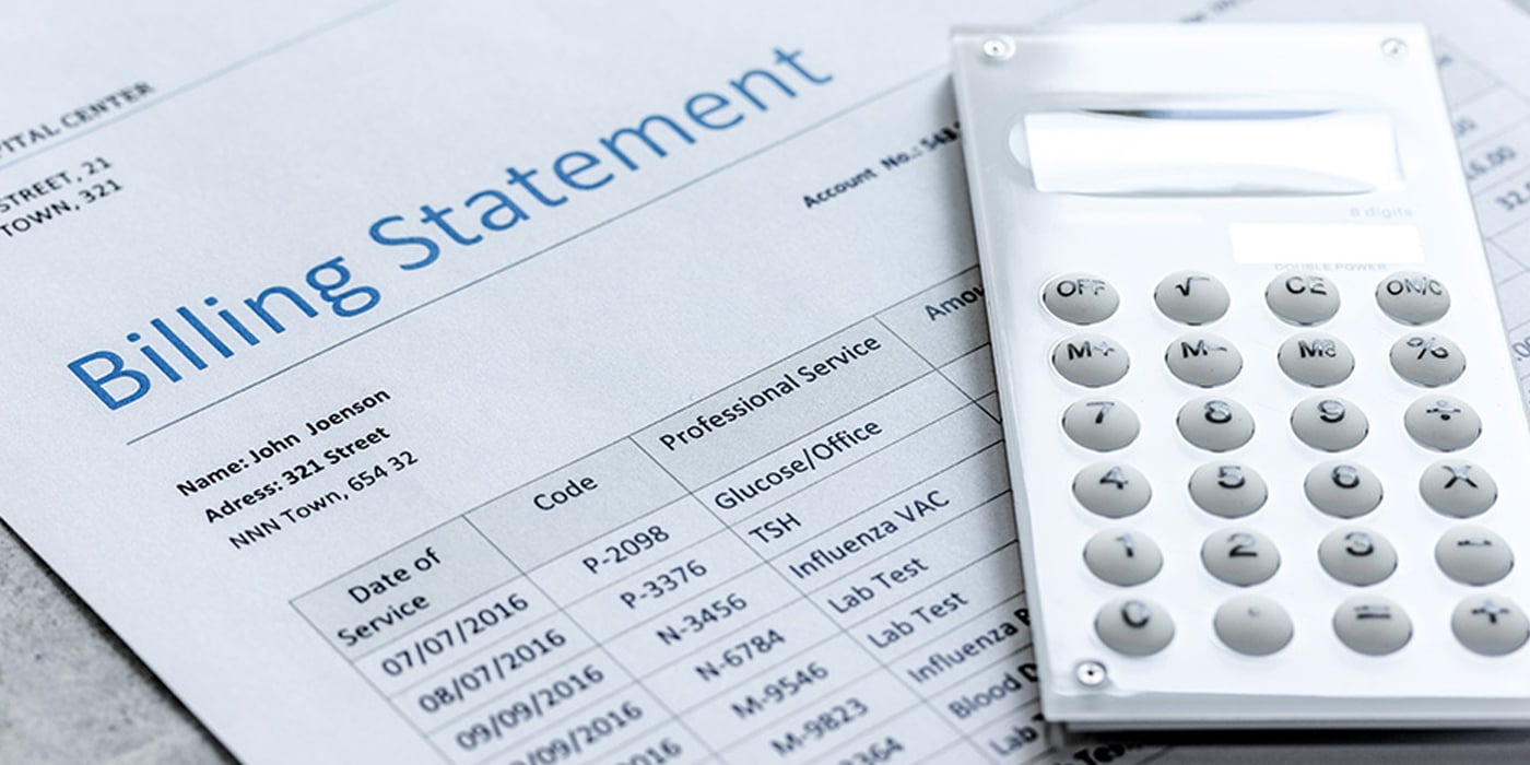A calculator on top of a billing statement