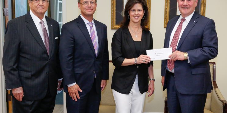 Alabama Power executives Mike Jordan and Leslie Sanders presents a grant for the College of Health Sciences to President Mike Williams and Chancellor Wayne Baker.