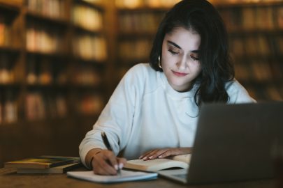 College student studying online at library