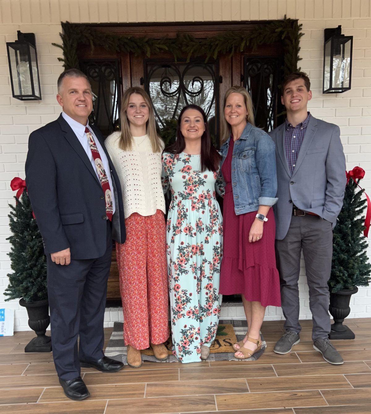 The Harris family poses in front of their front door. 