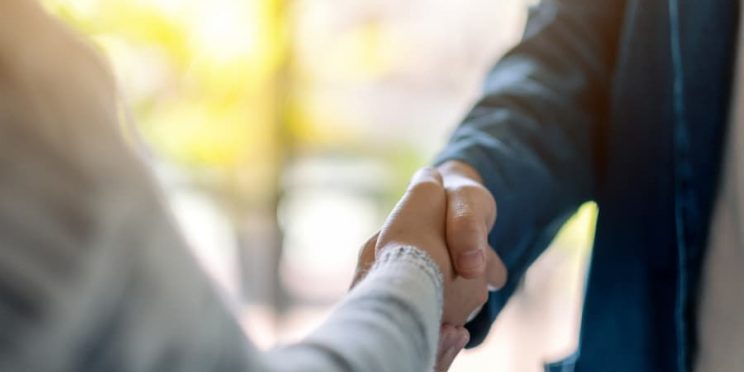 Two business executives shaking hands