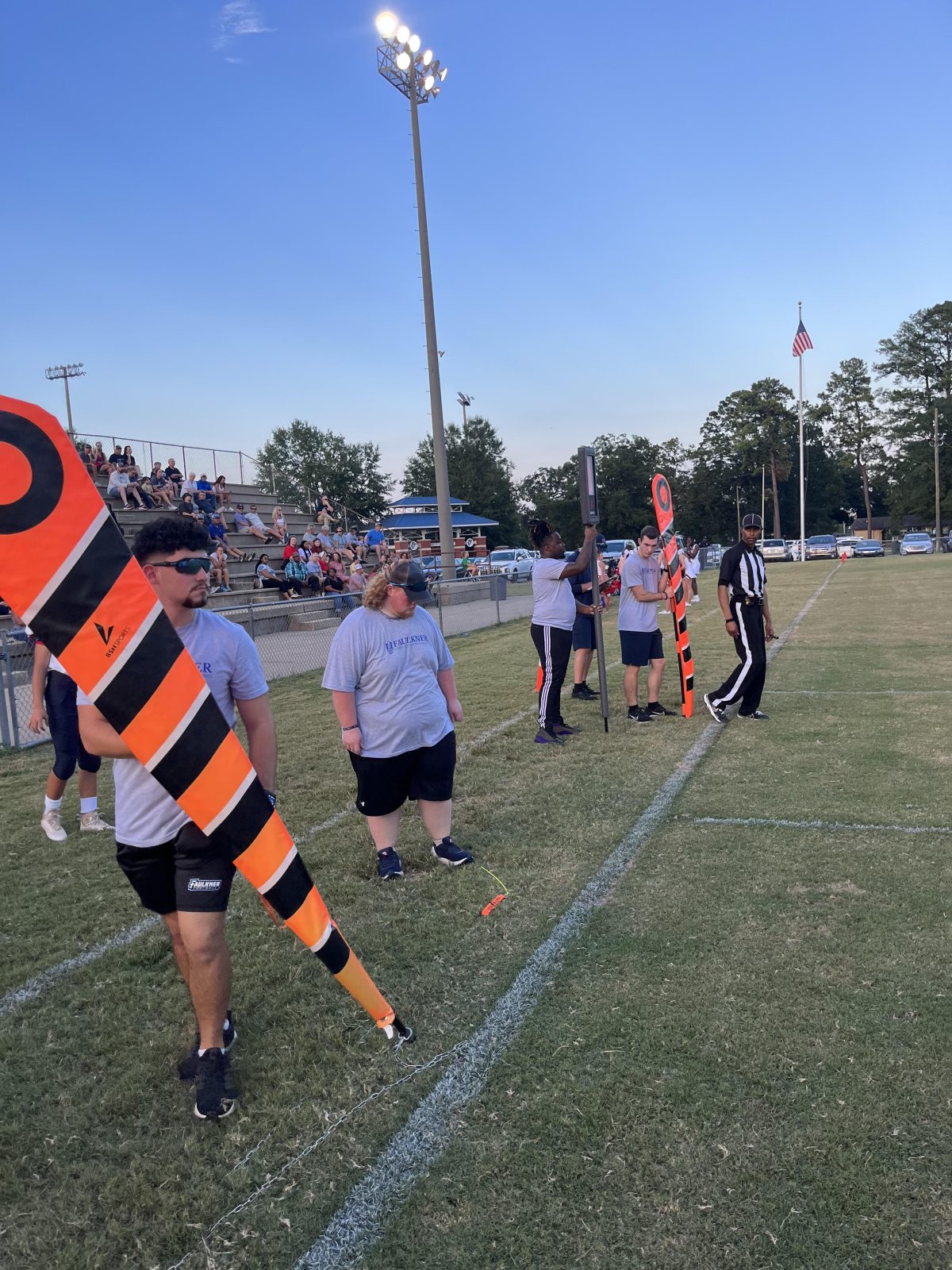 l-r Santos Sanchez, Bryce Hicks, Ja'Veon Kynard, and Nicholas Butts train with the chain crew at an ACA middle school football game. 