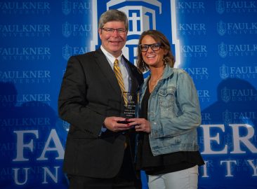 President Mitch Henry awards Ashley Abrams with the Accomplished Alumna Award.