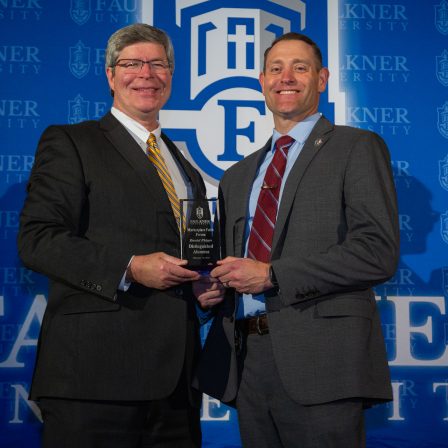 President Mitch Henry awards Captain Daniel Phipps at the 2024 Marketplace Faith Friday Forums.