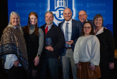 Joey Burns, center left, stands with his family after being awarded Distinguished Alumnus.