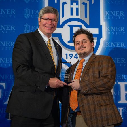 President Mitch Henry awards Jacob Payne. Payne works as a lawyer in Dothan, Alabama.