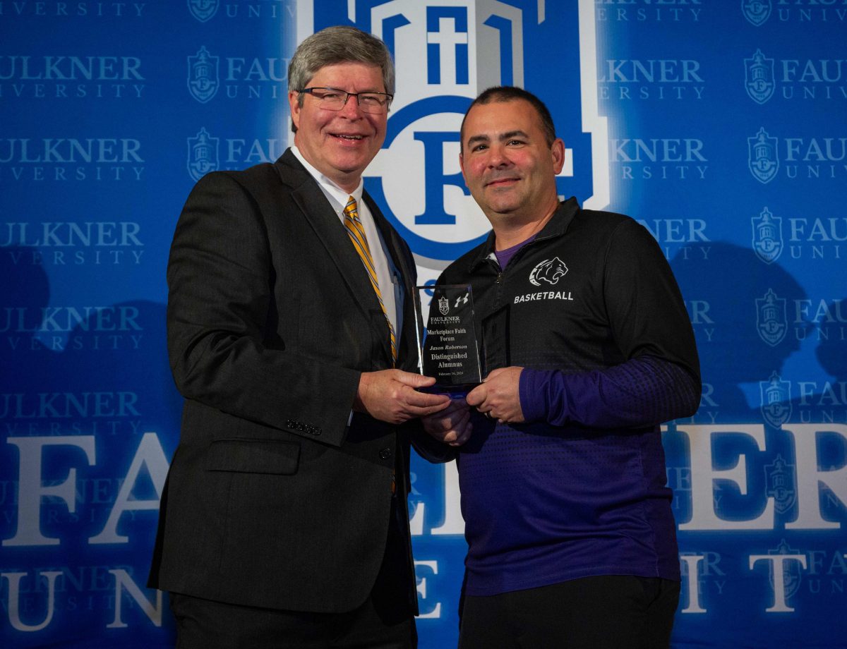 Faulkner President Mitch Henry, left, presents Jason Roberson with the Distinguished Alumnus Award. 