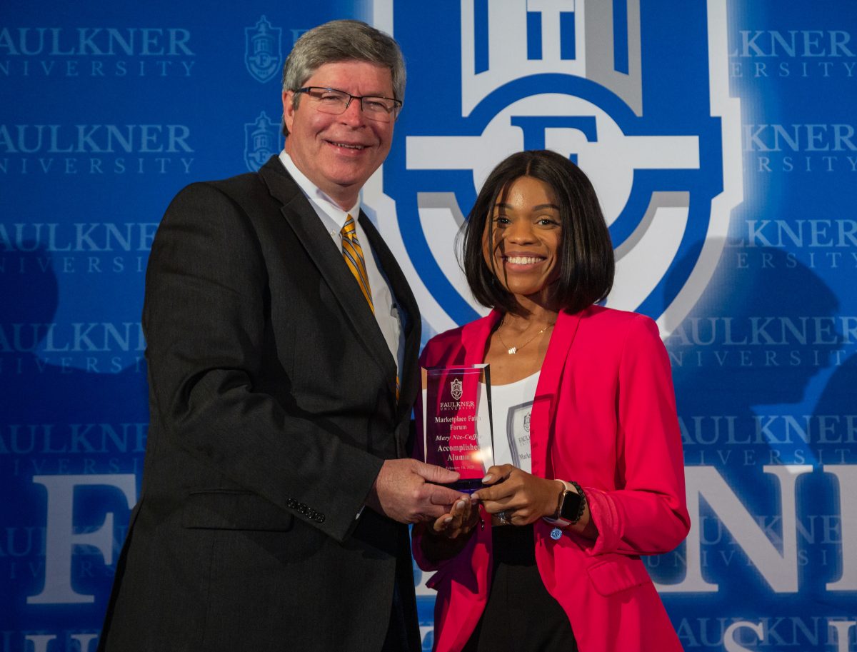 President Mitch Henry awards Mary Nix-Caffee with the Accomplished Alumna Award.