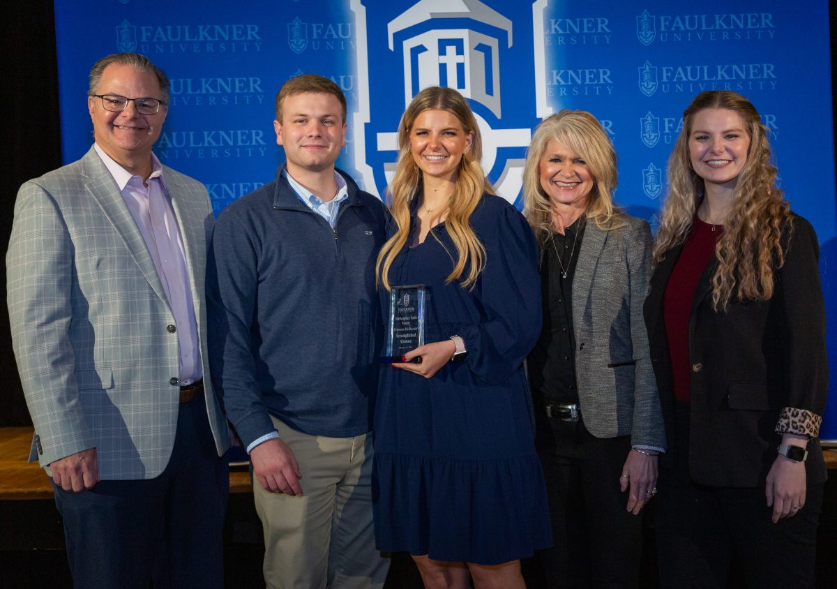 Victoria McDaniel, center poses with her family during the award ceremony for the 2024 Marketplace Faith Friday Forums.