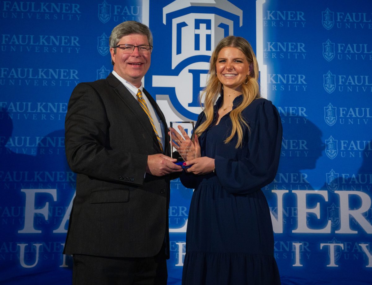 President Mitch Henry presents Victoria McDaniel with the Accomplished Alumna Award during the 2024 Marketplace Faith Friday Forums.