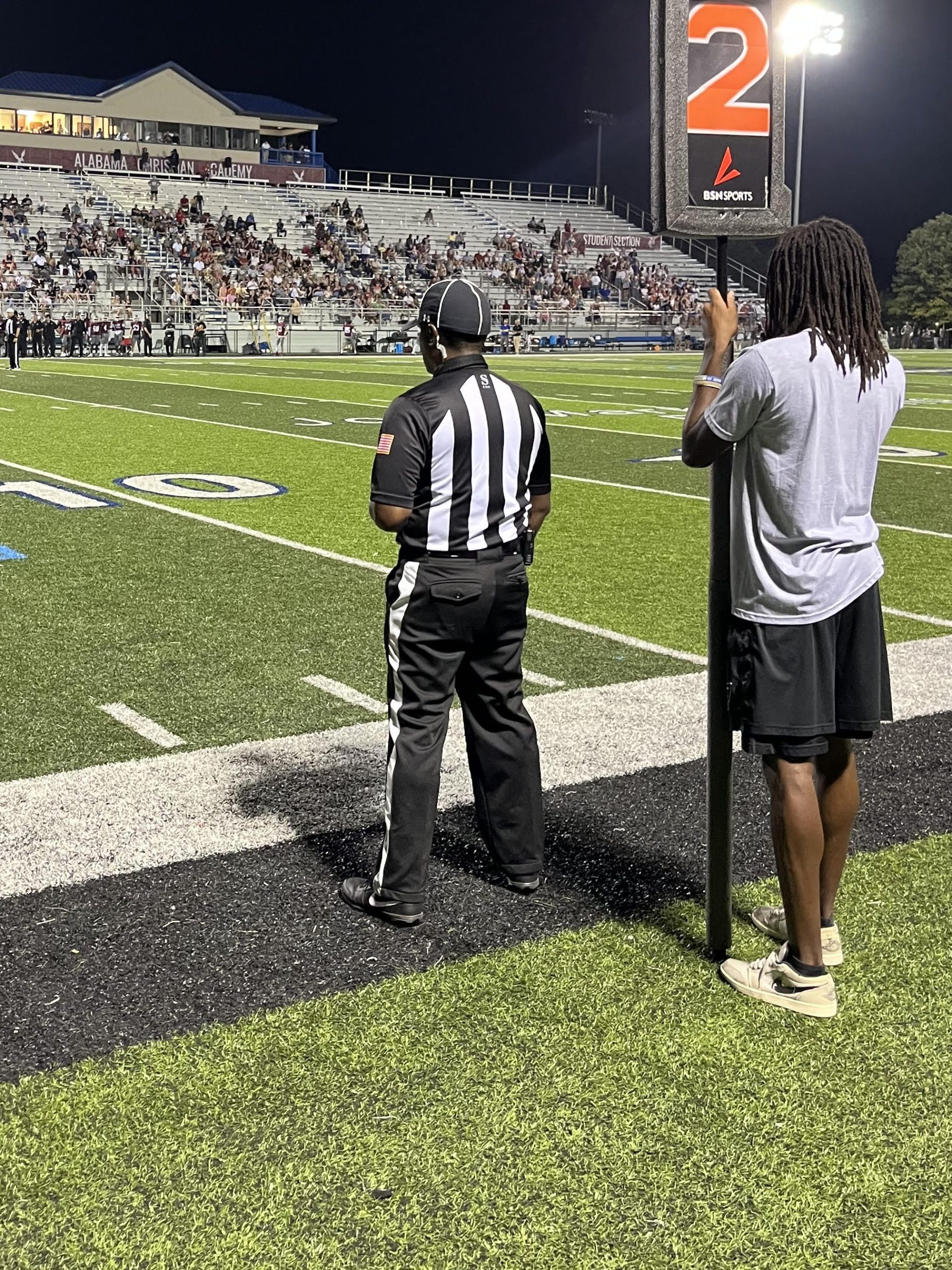 Malik Murray with the down marker shadowing a Line Official during an ACA varsity football game. 