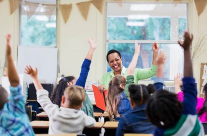 Teacher reading to elementary school children