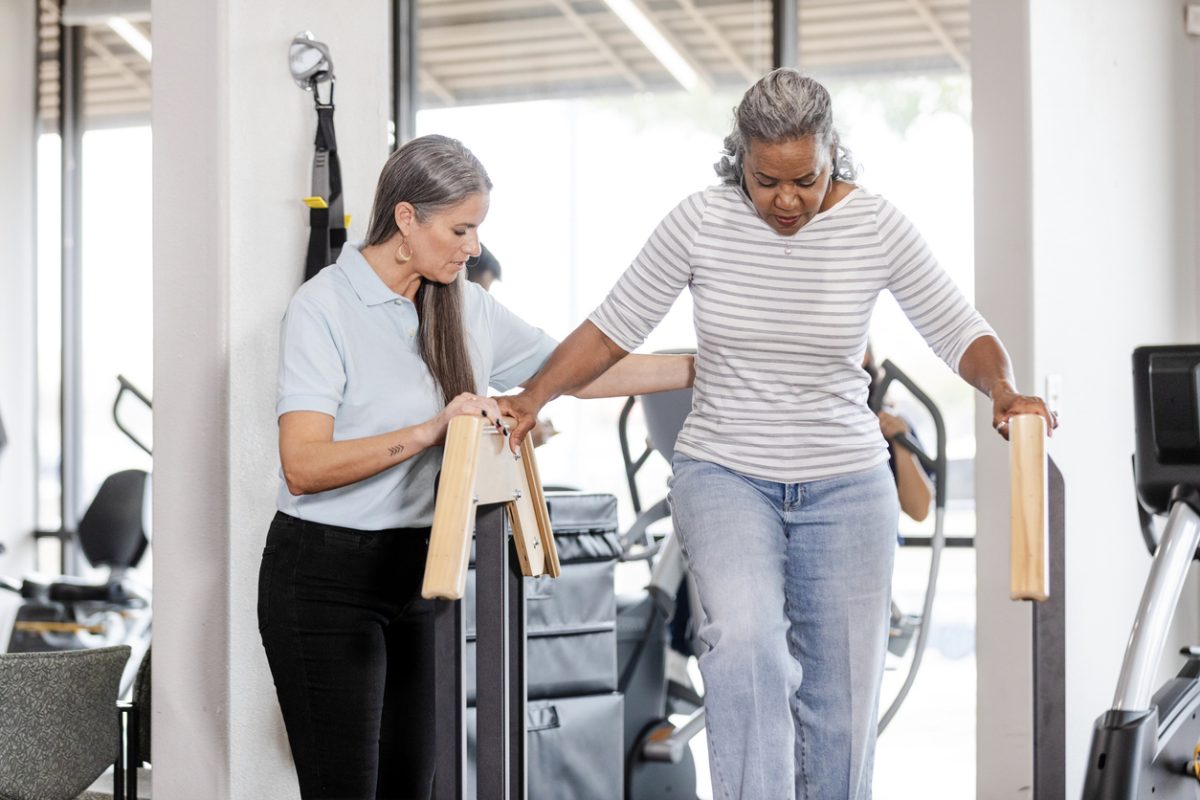 Physical therapist working with patient recovering from surgery