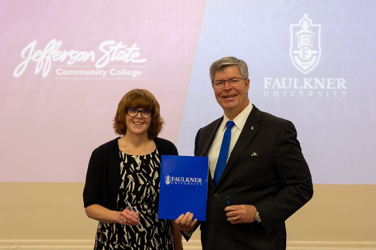 Dr. Danielle Coburn, left, and President Mitch Henry pose for a picture after signing the MOU.