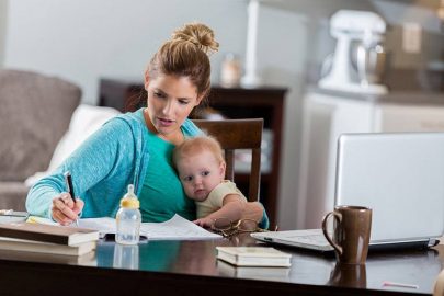 online Student Holding Child While Studying